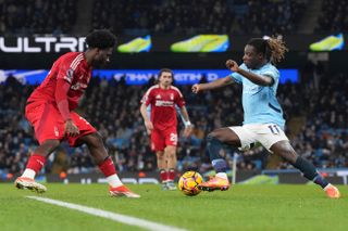 Manchester City's Jeremy Doku takes on Nottingham Forest's Ola Aina during the Premier League match at the Etihad Stadium in Manchester on 4 December, 2024