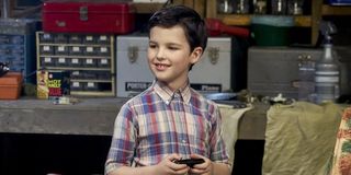 Young Sheldon with his train set