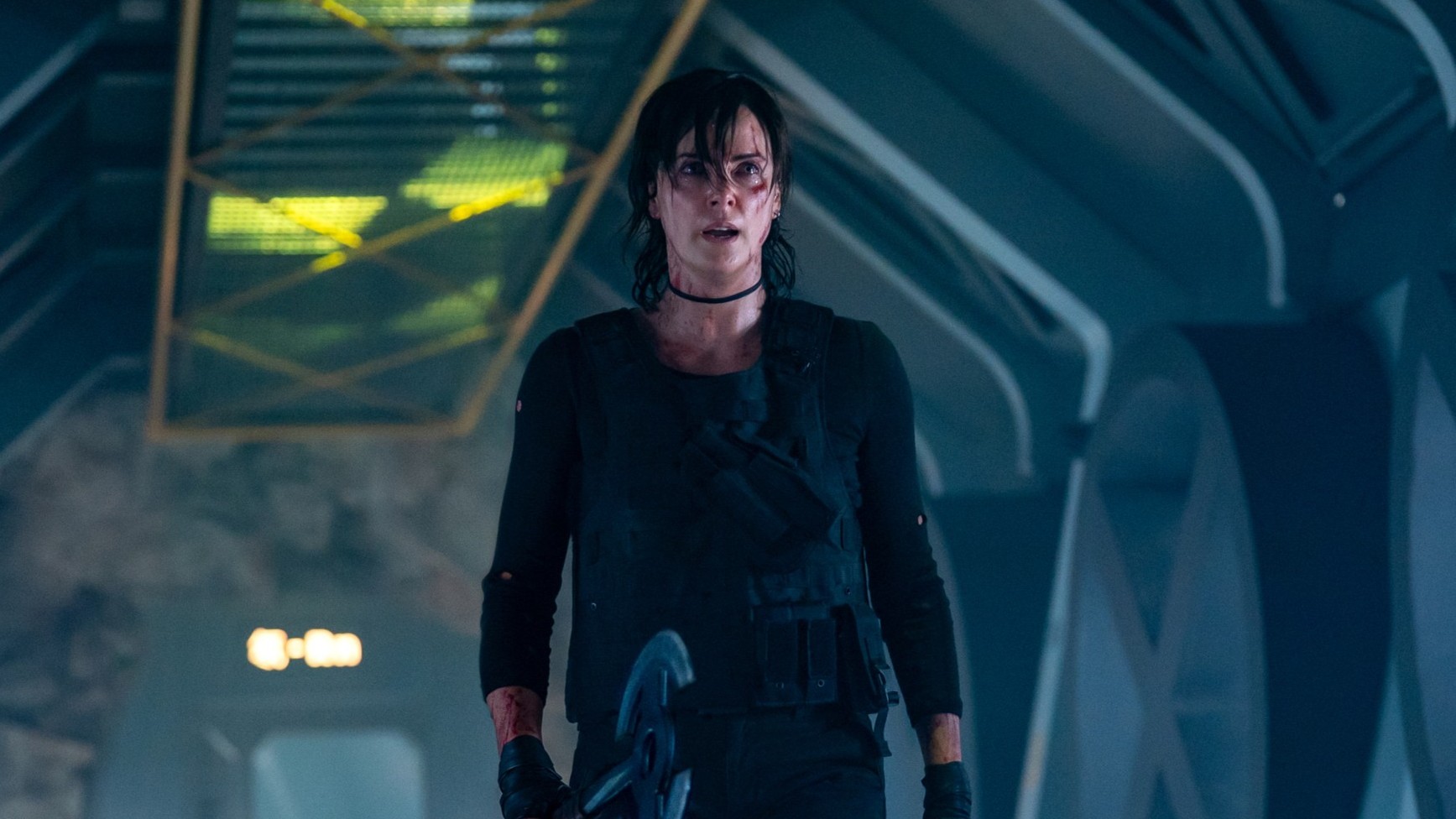 Charlize Theron cutup and holding an ax in The Old Guard 2