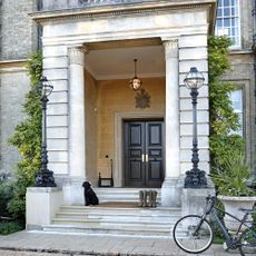 Exterior of house with black door and stairs