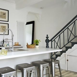 kitchen room with staircase metal stool and white wall