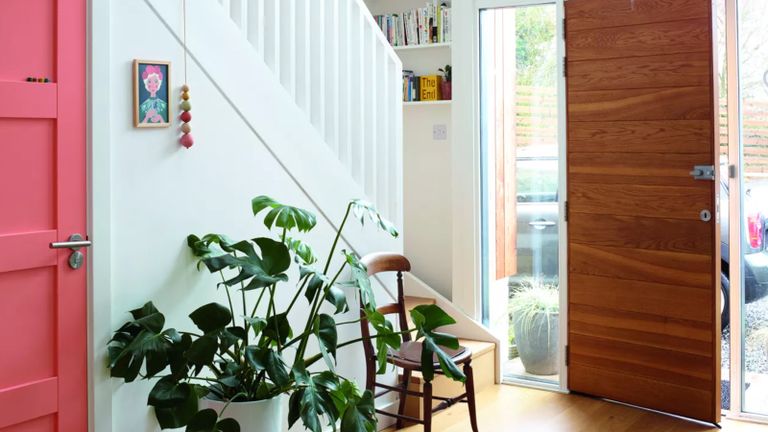 A bright hallway with natural wooden front door