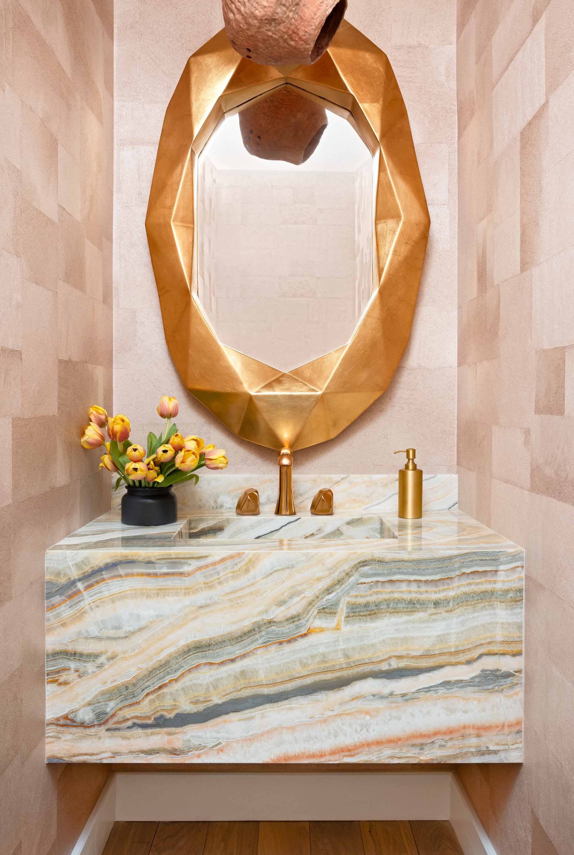 A gold and pink powder room
