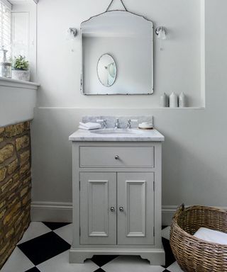 white bathroom with chequered tiles and wooden table top basin