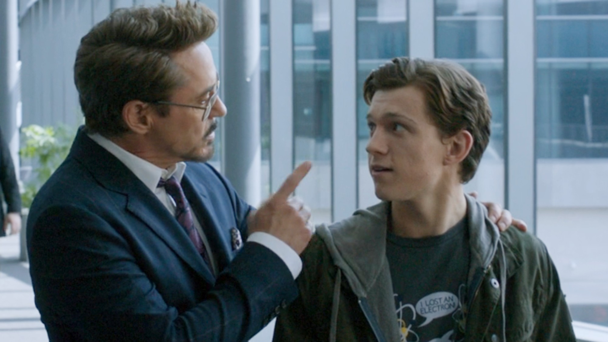 Tony pointing at Peter who is looking up at him in Spider-Man: Homecoming.