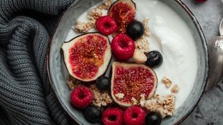 Bowl of Greek yogurt with pomegranates and berries