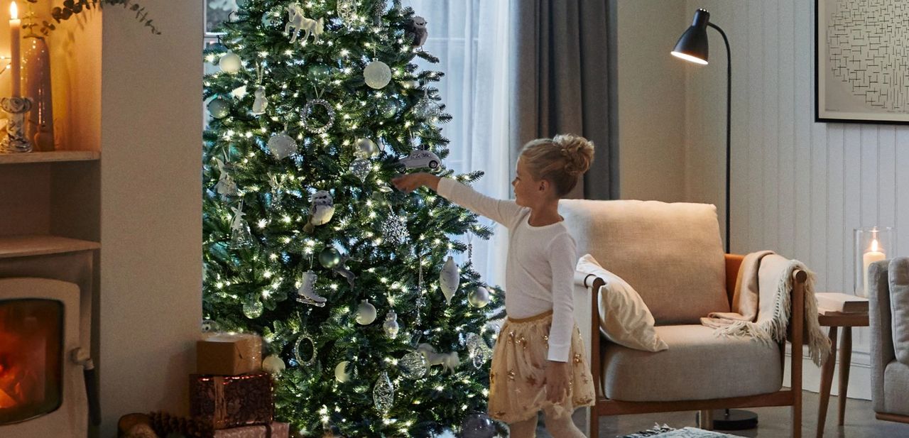 Girl decorating a Christmas tree