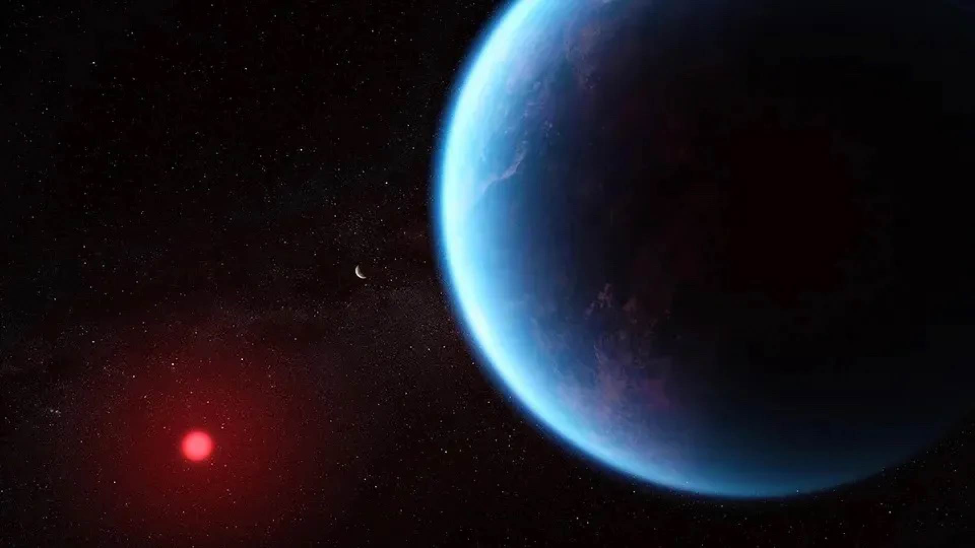 An artist's rendering of exoplanet K2-18b. It is blue and lit by a red star in the distance, and there is a tiny white crescent moon shape in the distance.