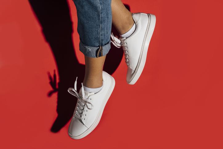  White trainers with red background 