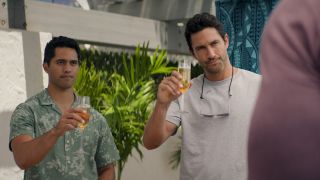 Kai Holman and Jesse Boone raising their champagne glasses in NCIS: Hawai&#039;i