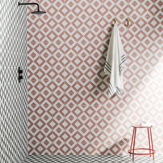 shower tiles in pink and black geometric pattern