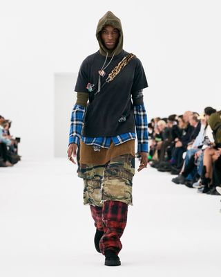 Man in layered outfit on Givenchy runway