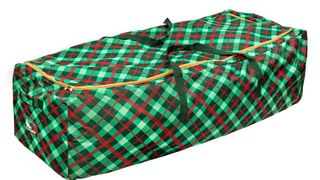 A green and red plaid Christmas tree storage bag, for the best Christmas tree storage bags.