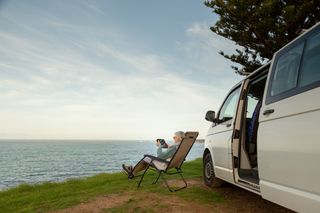 Senior woman enjoying time with her camper van.