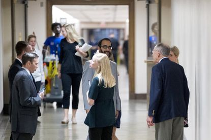 Sen. Chuck Grassley, R-Iowa, right, speaks with Garrett Ventry, a press adviser for the committee, center