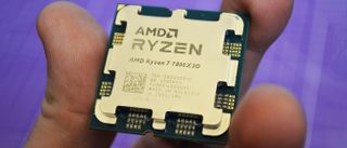 An AMD Ryzen 7 7800X3D in a man's hand