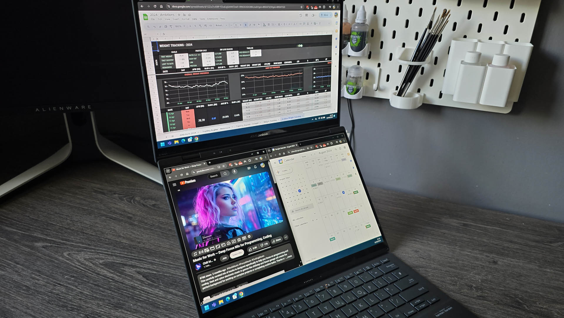 The Asus Zenbook Duo laptop photographed on a wooden desk.