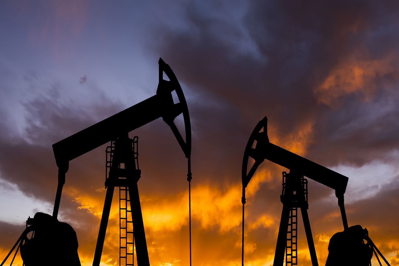 Oil pump on a sunset background. World Oil Industry