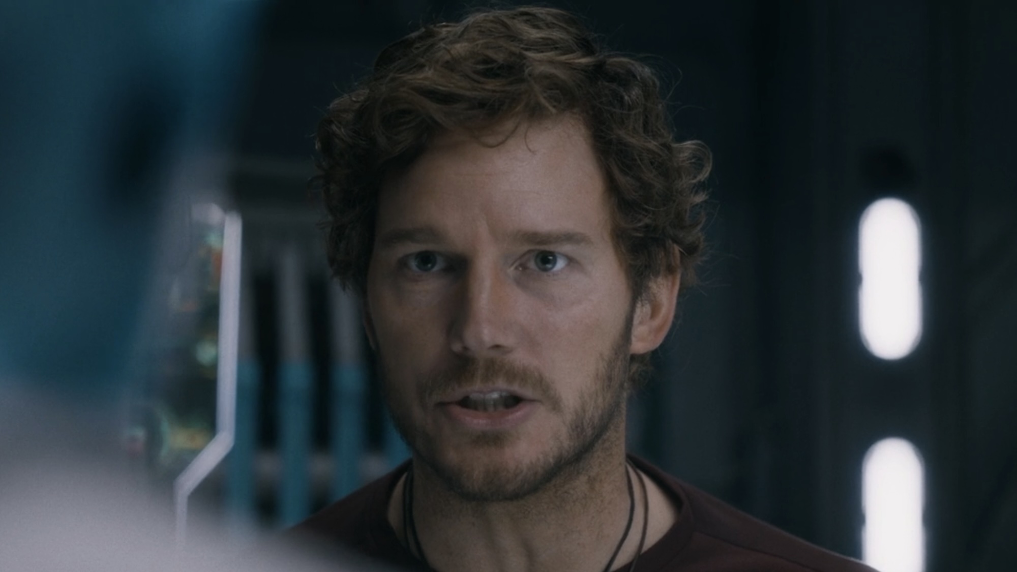 Chris Pratt's Star-Lord wearing a t-shirt and necklace talking about Rocket in Guardians 3. 