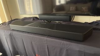 Nakamichi Shockwafe soundbar on a table below a TV