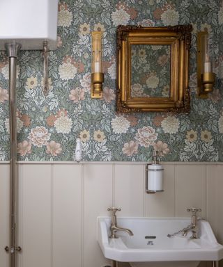 Bathroom with vintage wall lights on either side of the vanity mirror