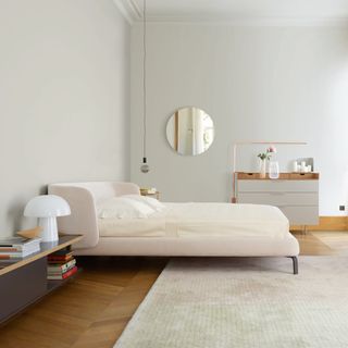 bedroom with pendant lighting and books