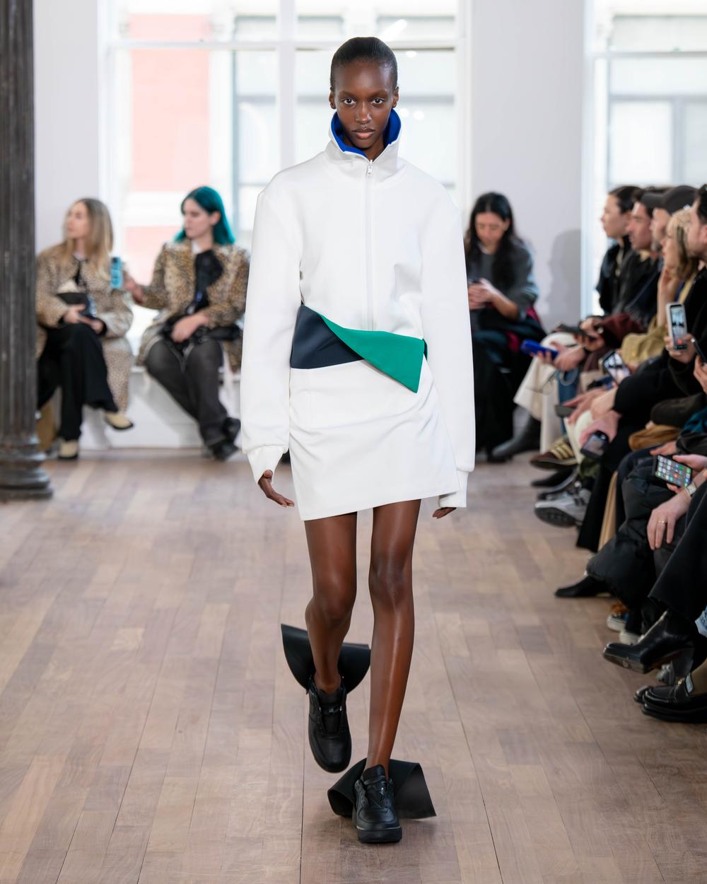 A LII model wearing stark white walking down the runway