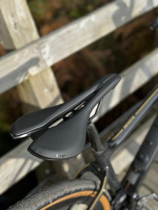 A black cut out saddle, the Liv SL Approach, with the gold detailing of the toptube.