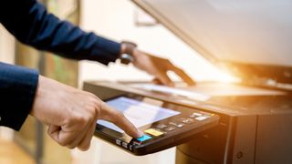 A person operating a printer.