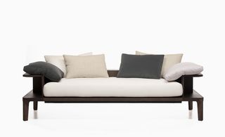 Sofa with dark wooden frame, white and grey cushions