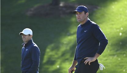 Scheffler and McIlroy wait to putt out on the green