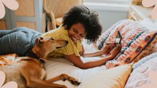Woman in bed with dog to support advice on why you should never share the bed with your pets in your bed in September 