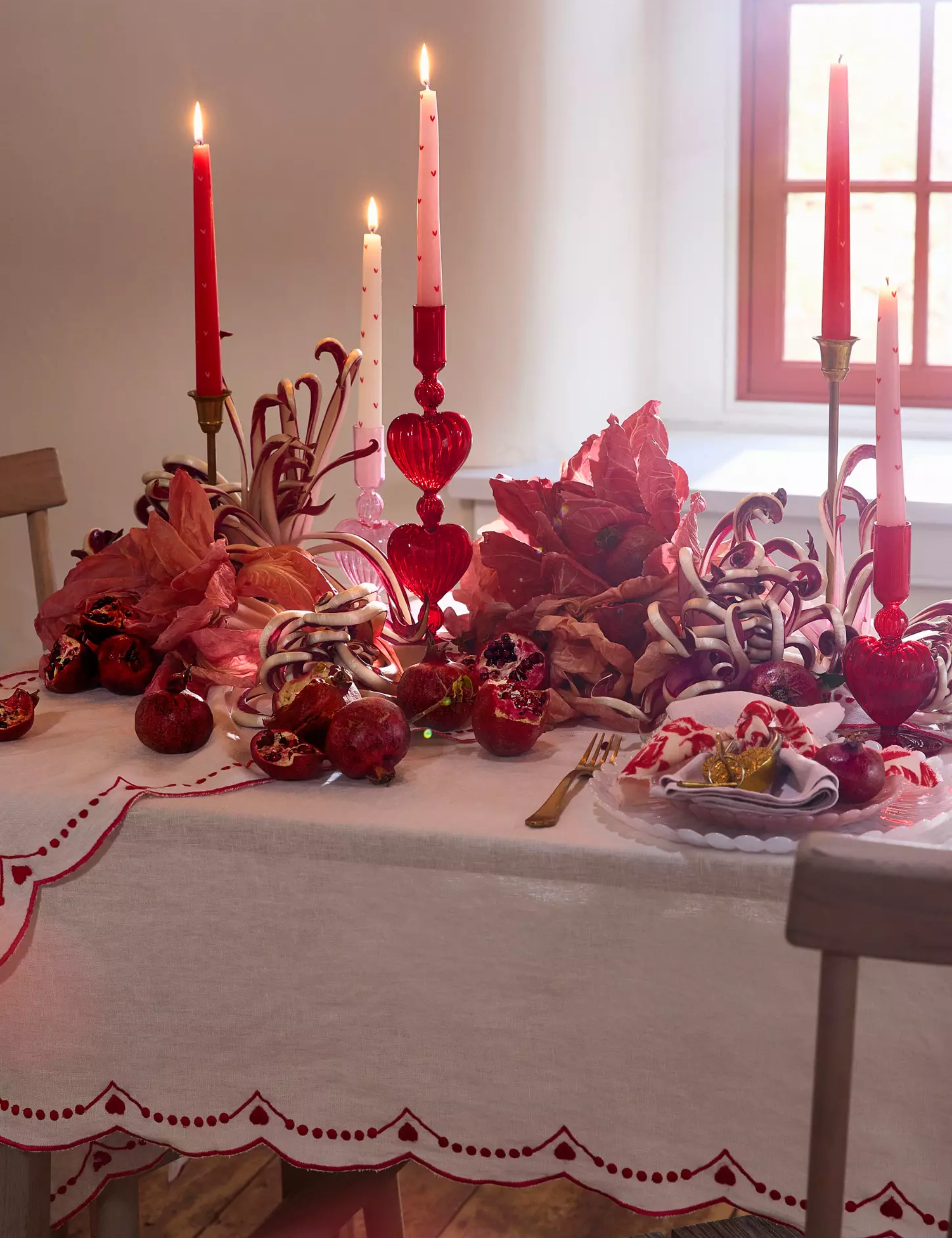 Valentine's Day tablescape styled with red-and-pink glassware and table linens