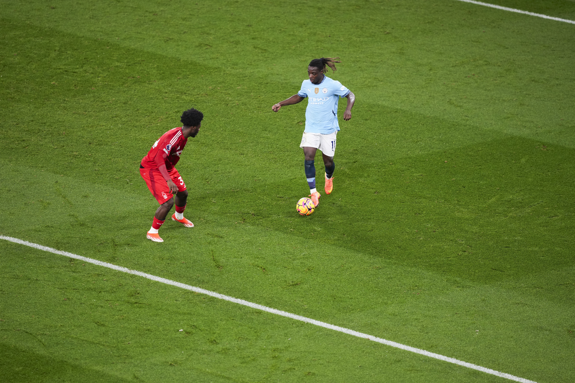 Manchester City player Jeremy Doke dribbling the ball, defended by Ola Aina