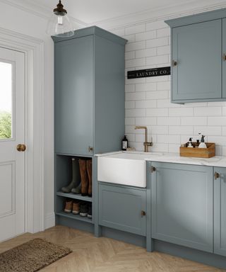 pale blue utility room cupboards with back door entrance and space for boots