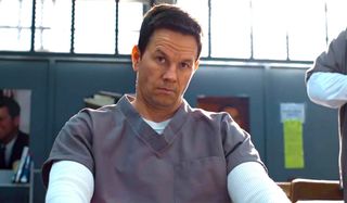 Spenser Confidential Mark Wahlberg sitting in prison, looking irritated