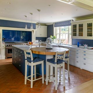 blue kitchen with dining table and cabinet