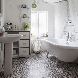 white bathroom with tiled walled and bathtub