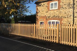 wooden picket fence at front of house