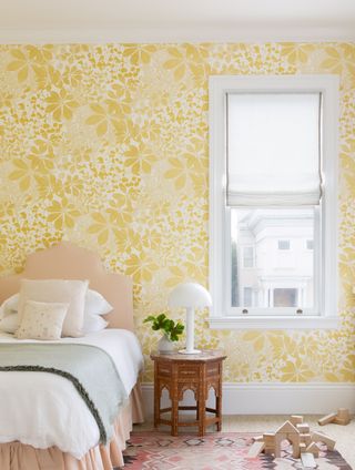 Yellow wallpapered girls bedroom