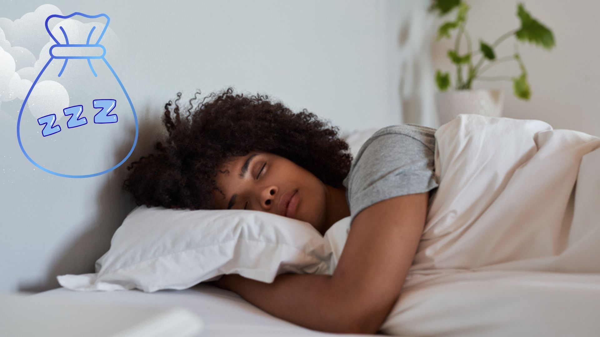 A woman with afro hair sleeping on her side in bed with white sheets and a plant in the background
