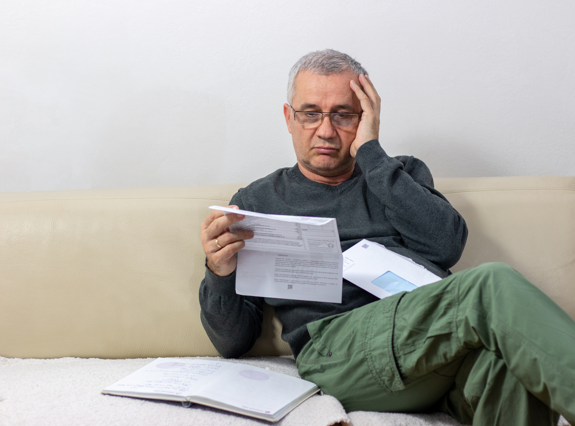 Man reading unexpected news in his mail.