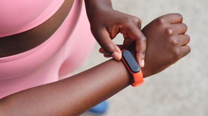 Woman checking the time on a fitness tracker