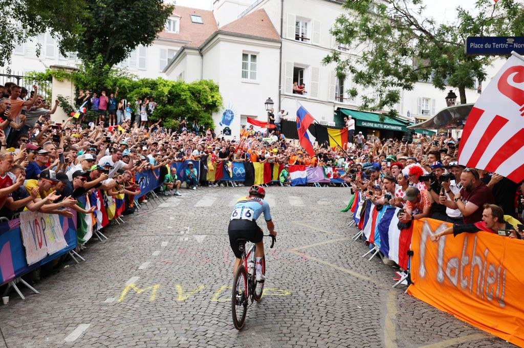 PARIS FRANCE AUGUST 03 Remco Evenepoel of Team Belgium attacks in the breakaway passing through the Cote de la butte Montmartre while fans cheers during the Mens Road Race on day eight of the Olympic Games Paris 2024 at trocadero on August 03 2024 in Paris France Photo by Tim de WaeleGetty Images