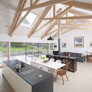 timber frame extension with exposed beams in open plan space