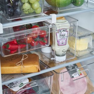 Under-shelf storage solution used on fridge shelf