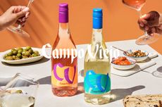 A bottle of white and a bottle of ros&eacute; wine, surrounded by little snacks