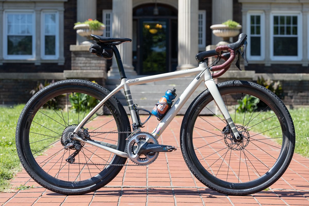 A white gravel bike with red bar tape