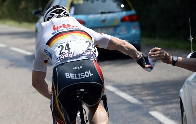 Andr&eacute; Greipel (Lotto Belisol) collects bottles on stage 14