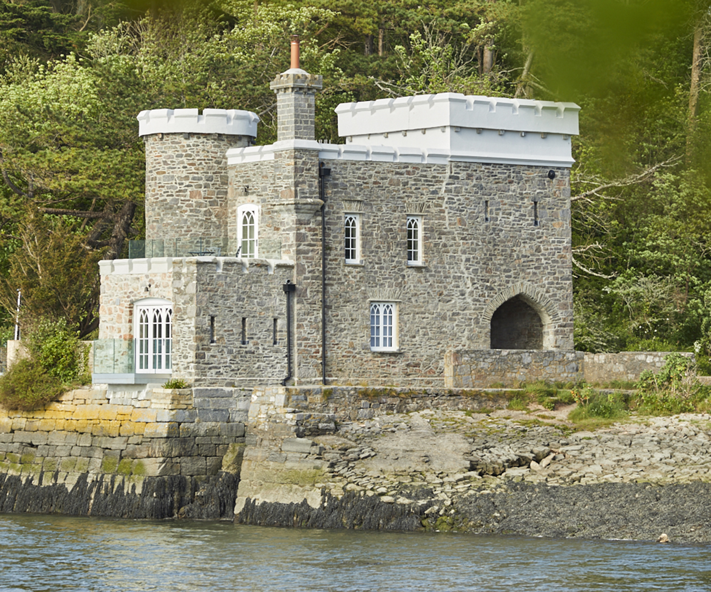A restored castle home next to a lake